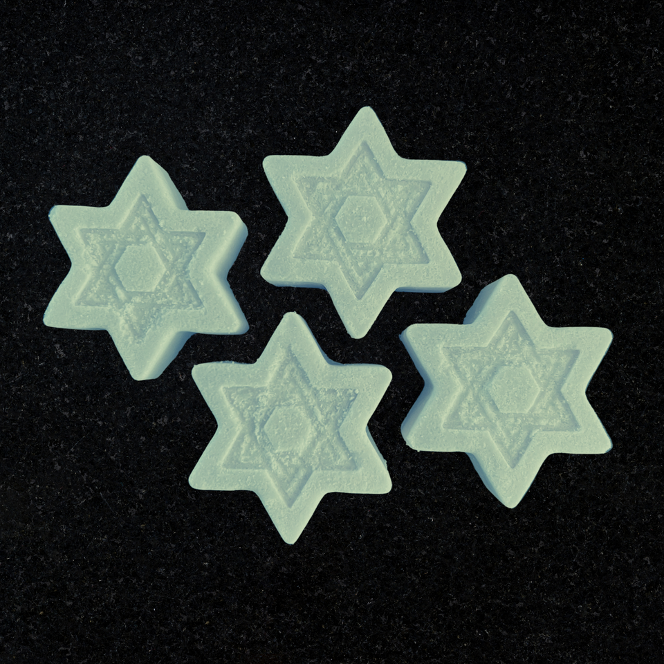 Four Star of David shaped shower steamers, light blue in color. The scent on these is menthol, eucalyptus, and peppermint.