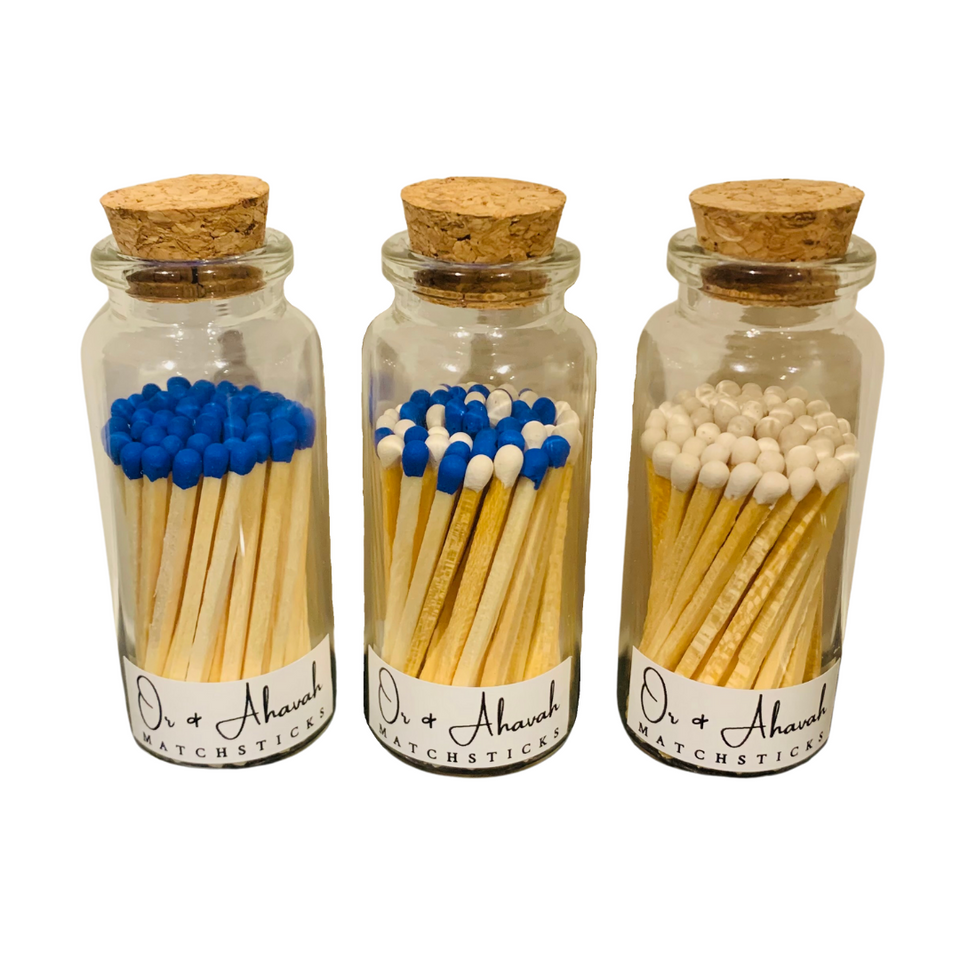 Colorful color-tip matchsticks. Three bottles are shown: one with blue tip matches, one with blue and white tip matches, and one with white tip matches.