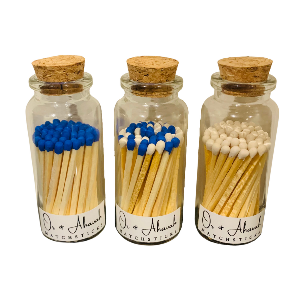 There are 3 corked glass bottles pictured. Each one has different colored color-tip matchsticks. These matchsticks have color tips in the colors: blue, white, or blue and white mix. Each container has a small sticker that says 