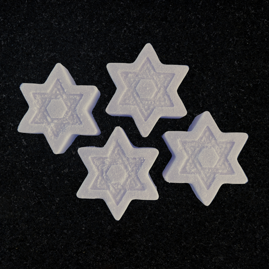 Four Star of David shaped shower steamers, light purple in color. The scent on these is lavender, lemon, and cedarwood.